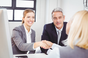 Smart business people handshaking with client in meeting room