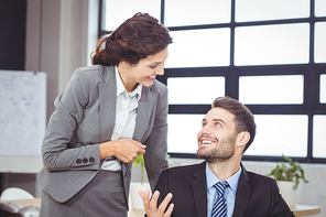 Young business people smiling while talking in office