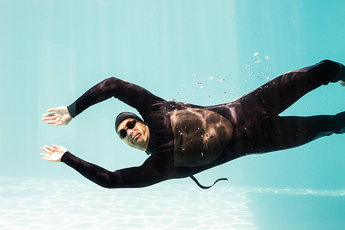 Portrait of young man swimming underwater