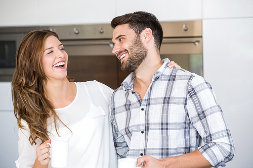 Close-up of cheerful young couple at home