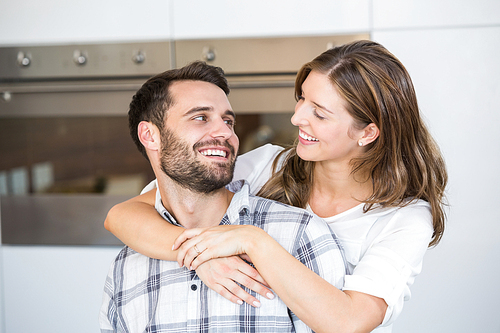 Close-up of smiling young couple at home