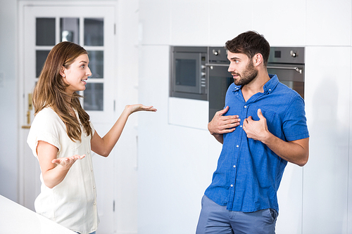 Woman arguing with partner in kitchen at home