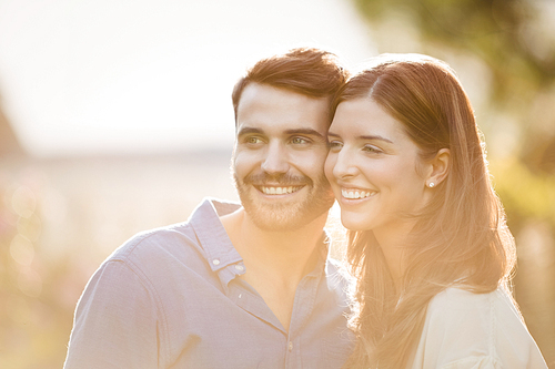 Close-up of couple looking away at park