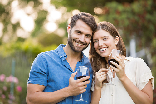 Portrait of couple with wine at park