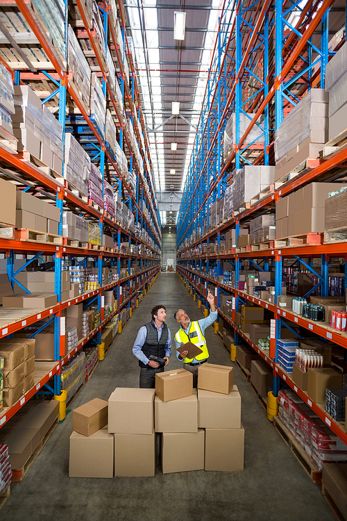 View of managers are looking up and pointing shelves in warehouse