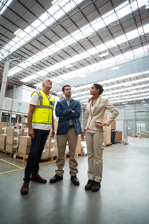 Low angle view of worker team is talking in a warehouse