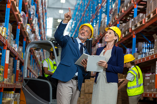 Portrait of managers are pointing and looking shelves in a warehouse