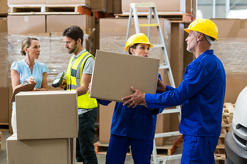 Coworkers looking at each other in warehouse
