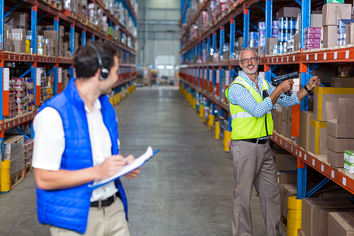 Workers colleague smiling at each other in warehouse