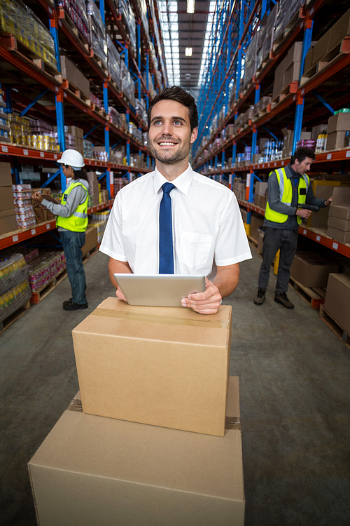 Businessman holding a digital tablet in warehouse