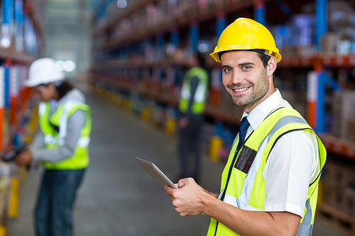 Worker in warehouse  with yellow safety vest