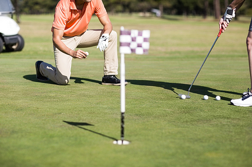 Cropped image of woman playing golf on field
