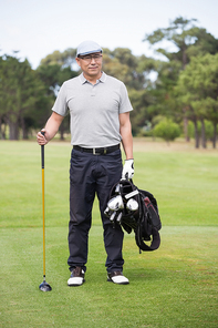 Portrait of golfer standing on field