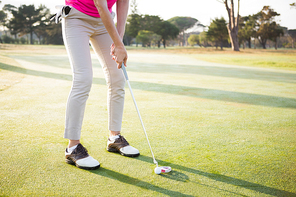 Close up of woman golfer preparing her shot on a field