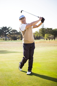 Portrait of sportsman playing golf on a field