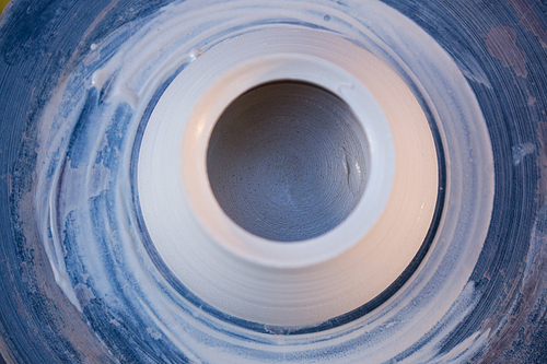Close-up of molding pot on pottery wheel in pottery workshop