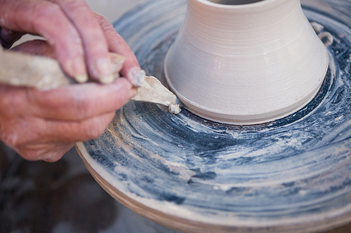 Close-up of potter making pot in pottery workshop