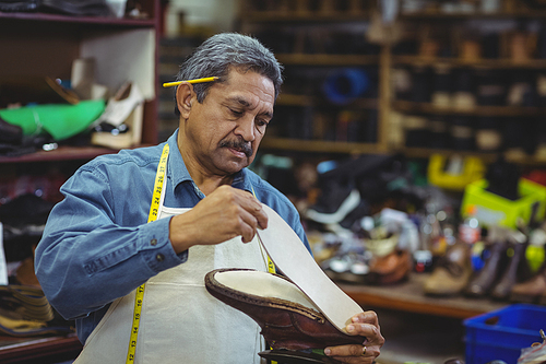 Shoemaker repairing a shoe in workshop