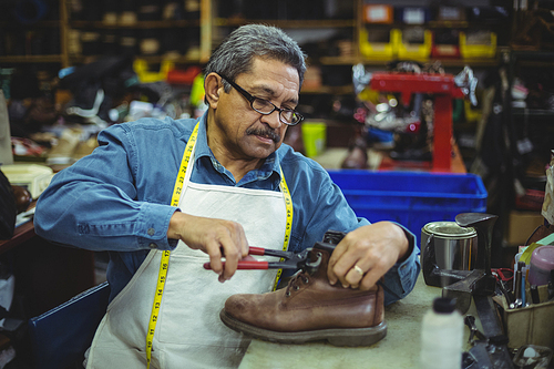 Shoemaker repairing a shoe in workshop