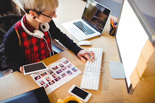 Female graphic designer working on computer at office