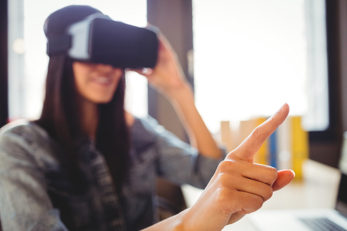 Woman using virtual reality headset at office