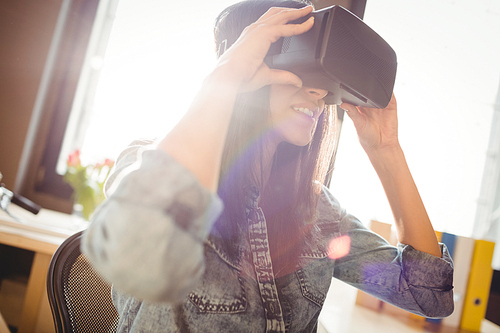 Woman using virtual reality headset at office