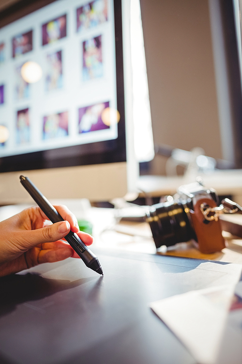 Close-up of female graphic designer using graphic tablet