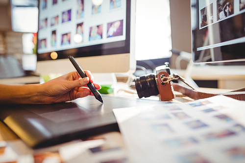 Close-up of female graphic designer using graphic tablet