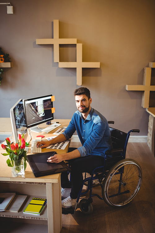 Portrait of graphic designer using a graphics tablet in office