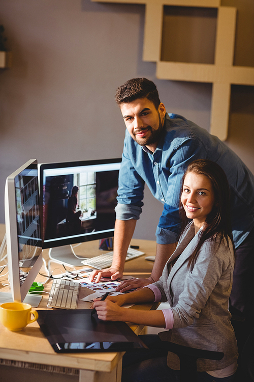 Portrait of graphic designers using a graphics tablet in office