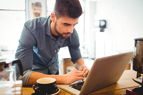 Graphic designer working on laptop at office