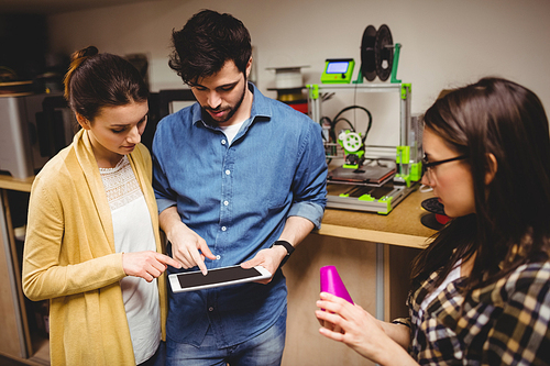 Team of graphic designers interacting using digital tablet in office