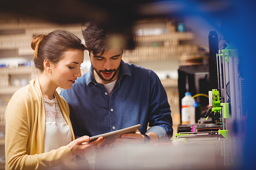 Graphic designers interacting using digital tablet in office