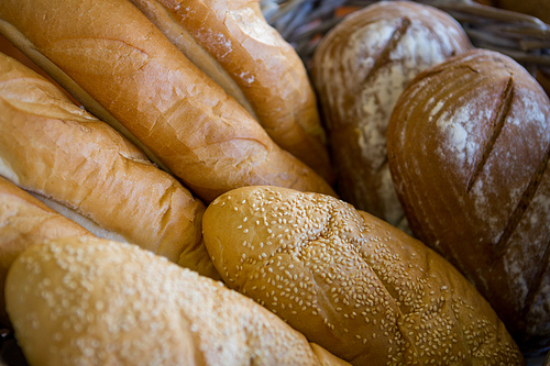 Close-up of various breads in basket at supermarket