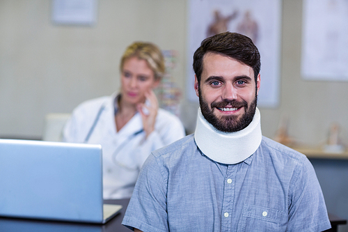 Portrait of patient with a cervical collar in clinic