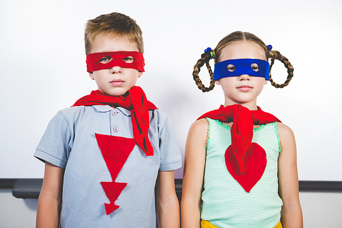 Portrait of boy and girl pretending to be a superhero