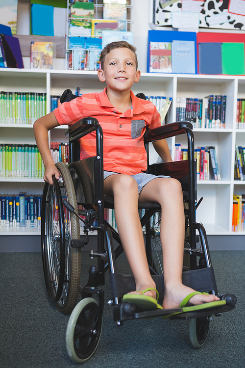 Portrait of disabled schoolboy in library at school