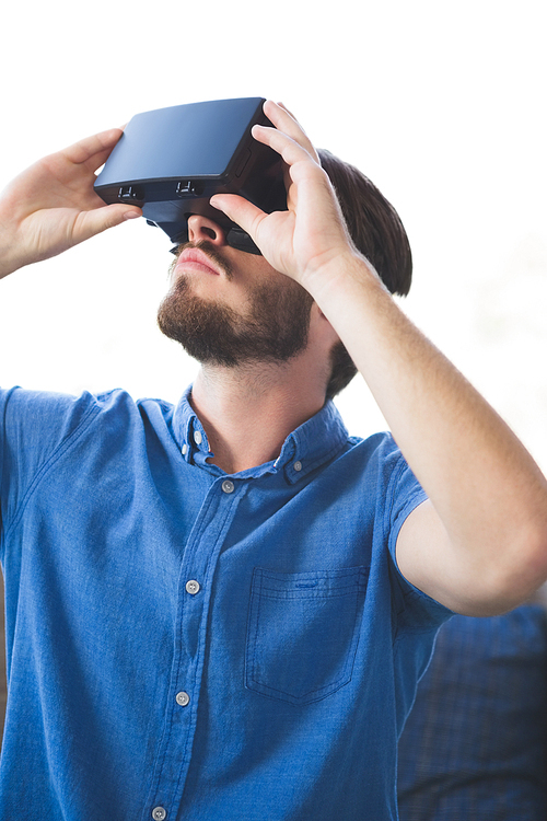 Close-up of man using virtual reality glasses at home