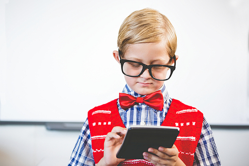 Close-up of schoolkid pretending to be a teacher in classroom at school