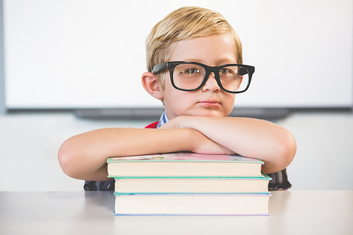 Portrait of schoolkid pretending to be a teacher in classroom at school