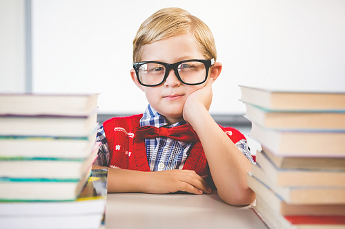 Portrait of schoolkid pretending to be a teacher in classroom at school