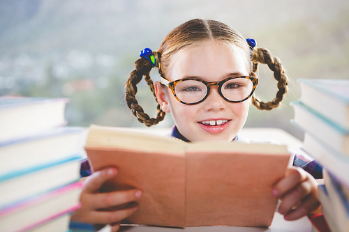 Close-up of schoolkid reading book in classroom at school