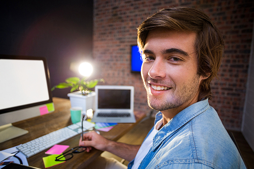 Portrait of smiling young man in creative office