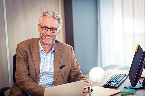 Portrait of businessman smiling in office