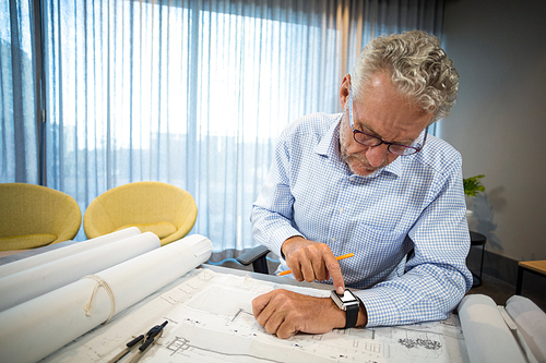 Man adjusting time on his watch in office