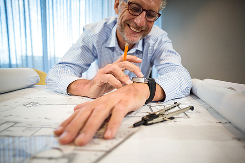 Man adjusting time on his watch in office