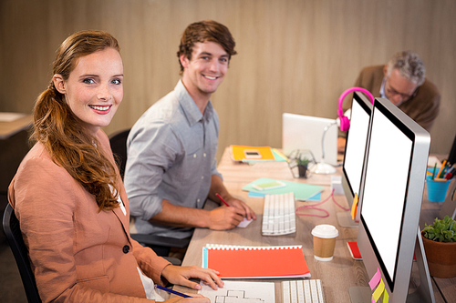 Portrait of smiling business people sitting in office