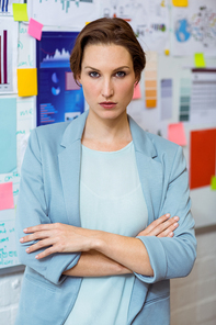 Portrait of businesswoman standing with arms crossed in office
