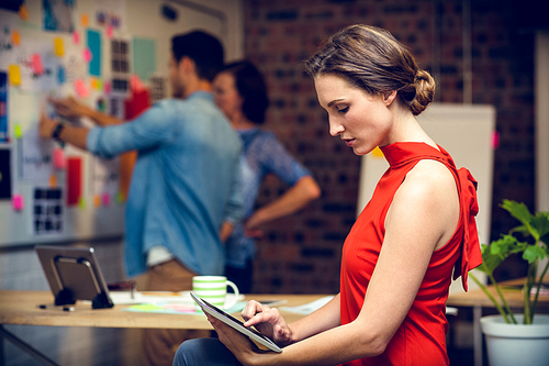 Businesswoman using digital tablet in office