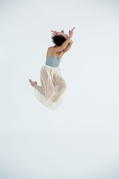 Dancer practicing contemporary dance in dance studio